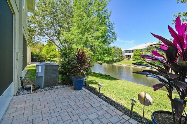 view of patio / terrace with a water view and central AC unit