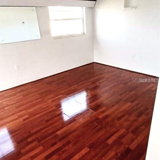 unfurnished room with hardwood / wood-style flooring