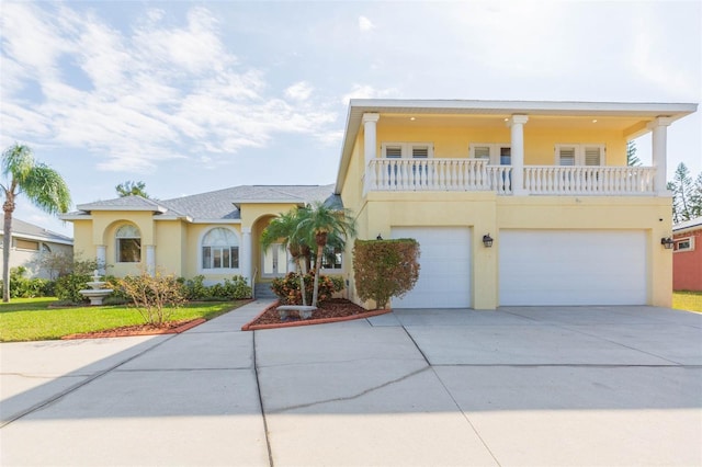 view of front of property with a garage and a balcony