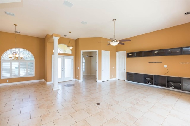 unfurnished living room featuring ceiling fan with notable chandelier, light tile patterned flooring, high vaulted ceiling, and french doors