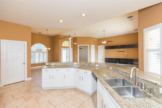 kitchen featuring ceiling fan with notable chandelier, sink, hanging light fixtures, light tile patterned floors, and white cabinetry