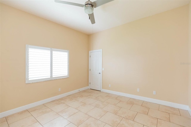 tiled spare room featuring ceiling fan