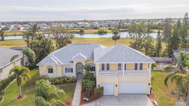 view of front of house featuring a balcony, a water view, and a garage