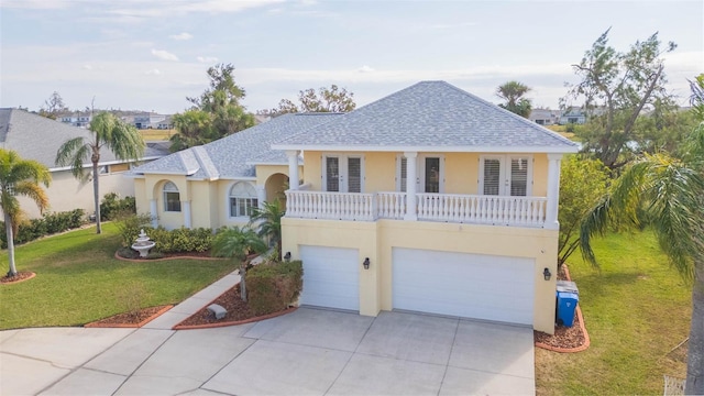 view of front of home featuring a balcony, a garage, and a front lawn