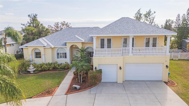 view of front of home featuring a garage and a front lawn