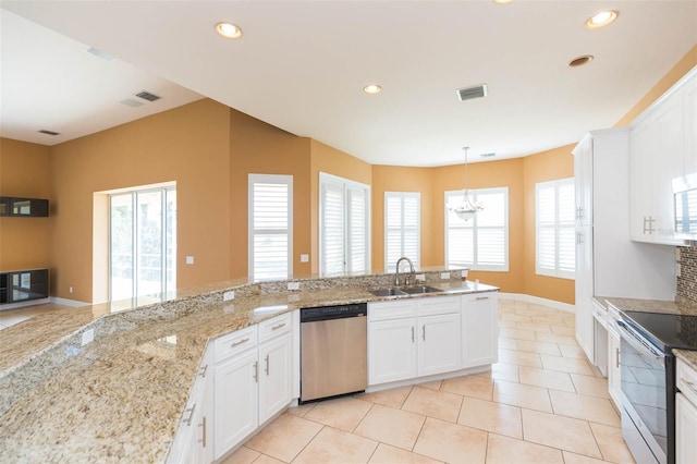 kitchen featuring white cabinetry, sink, hanging light fixtures, light tile patterned floors, and appliances with stainless steel finishes