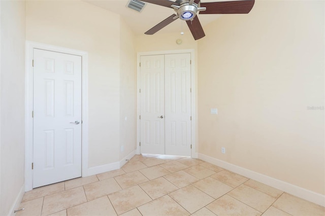 unfurnished bedroom with ceiling fan and light tile patterned floors