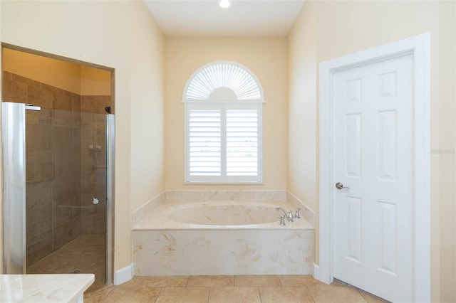 bathroom with tile patterned flooring and independent shower and bath