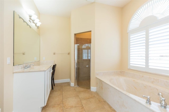 bathroom with tile patterned floors, vanity, and separate shower and tub