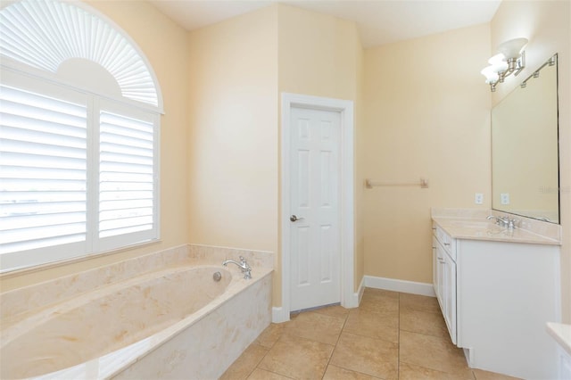 bathroom featuring tile patterned flooring, vanity, and a tub