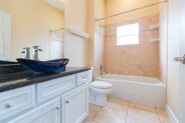 full bathroom featuring tile patterned floors, vanity, toilet, and tiled shower / bath combo