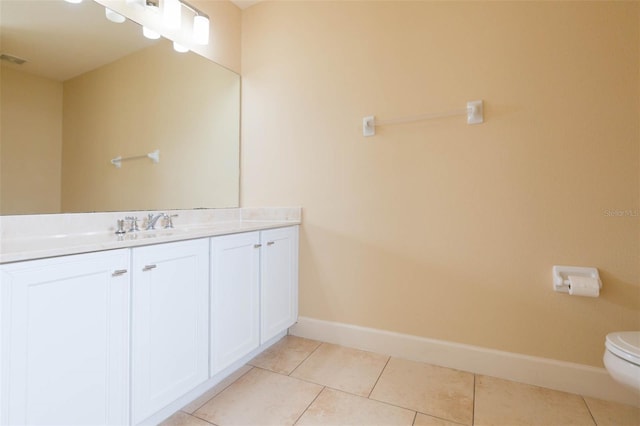 bathroom with tile patterned floors, vanity, and toilet