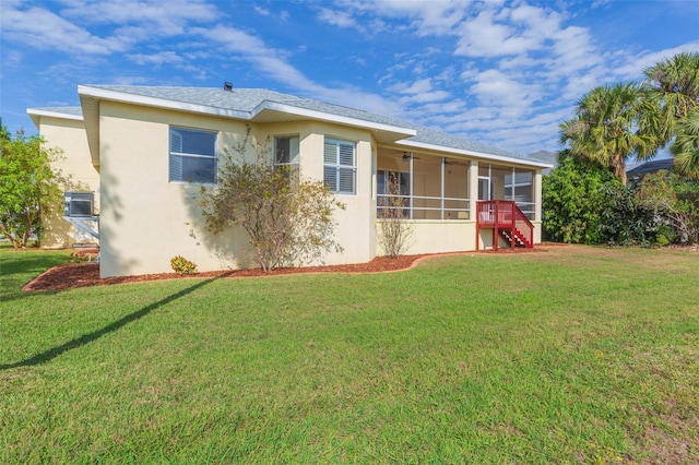 rear view of property featuring a yard, central AC unit, and a sunroom