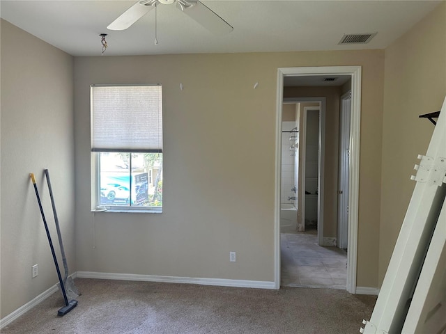 carpeted spare room with ceiling fan