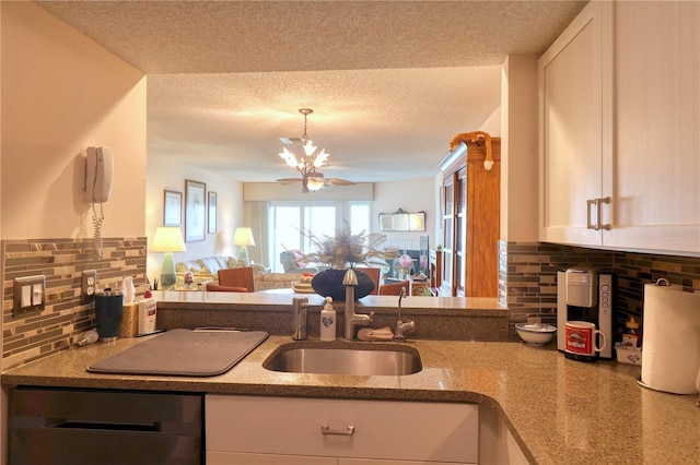 kitchen with decorative backsplash, a textured ceiling, sink, dishwasher, and white cabinetry