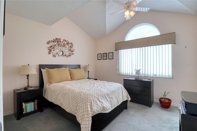 carpeted bedroom with a textured ceiling, ceiling fan, and vaulted ceiling