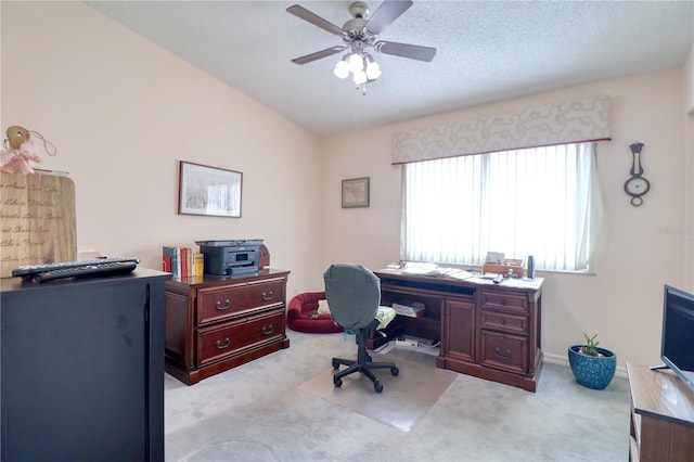 carpeted office space with a textured ceiling, ceiling fan, and lofted ceiling