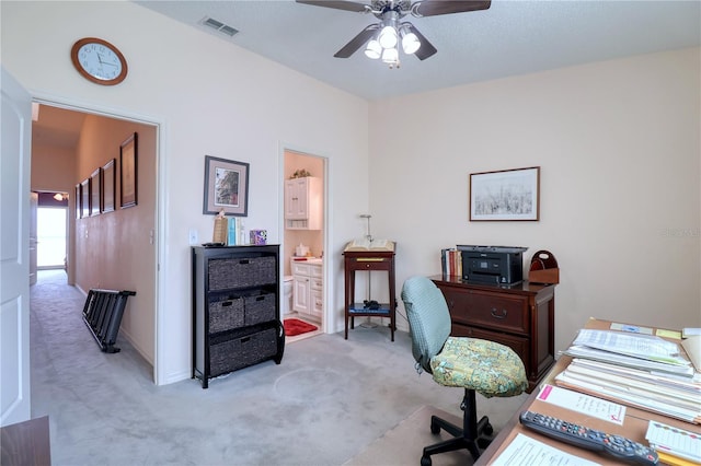 office space with light carpet and ceiling fan