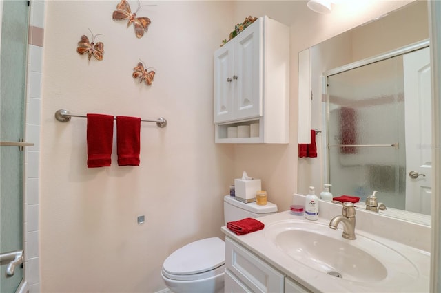 bathroom featuring walk in shower, vanity, and toilet