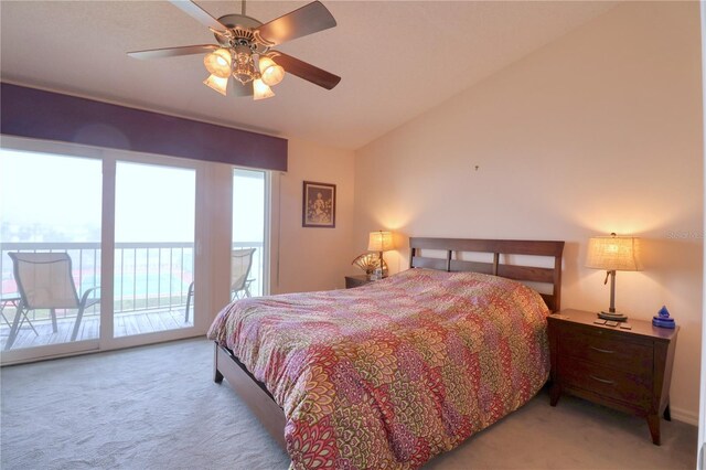 bedroom featuring ceiling fan, access to exterior, light colored carpet, and vaulted ceiling