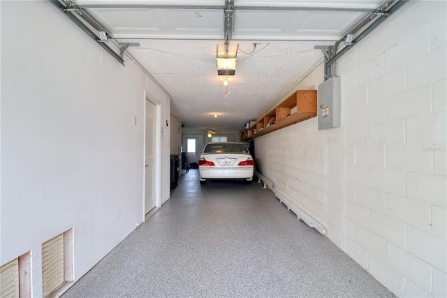 garage featuring electric panel and a garage door opener