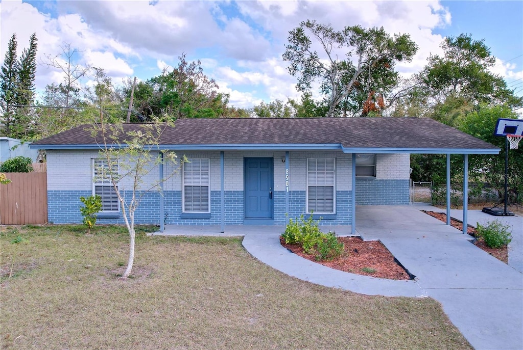 single story home with a carport and a front lawn