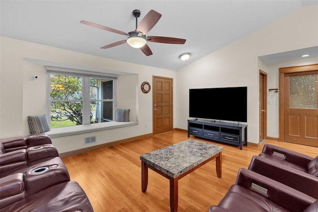 living room featuring ceiling fan, lofted ceiling, and light hardwood / wood-style floors