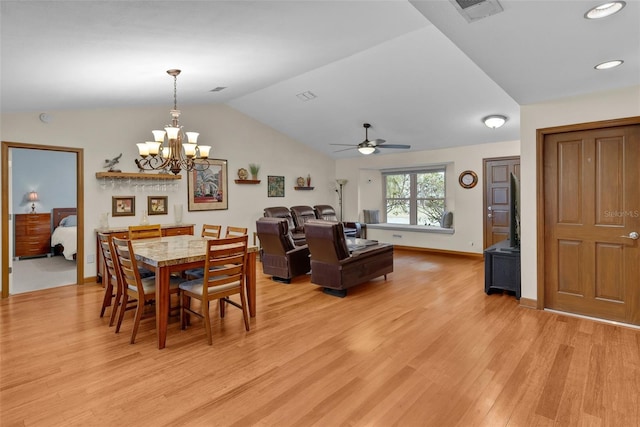 dining area with vaulted ceiling, ceiling fan with notable chandelier, and light hardwood / wood-style flooring