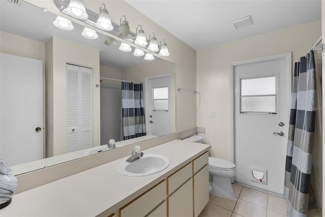 bathroom with vanity, toilet, and tile patterned flooring