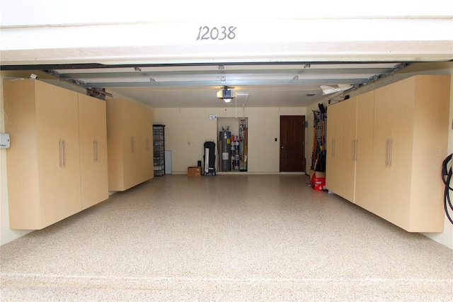 garage with a garage door opener and water heater