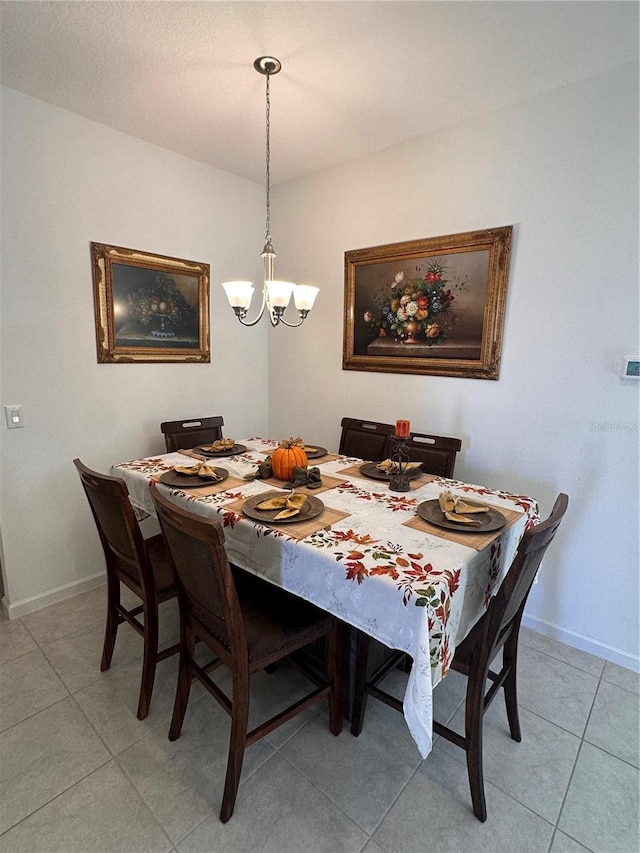 tiled dining space with an inviting chandelier