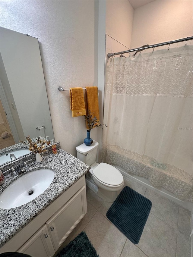 full bathroom with tile patterned floors, vanity, shower / tub combo, and toilet