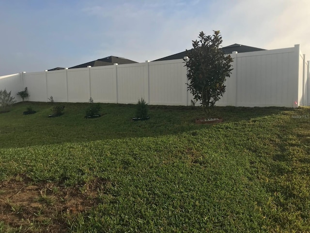 view of yard with a fenced backyard