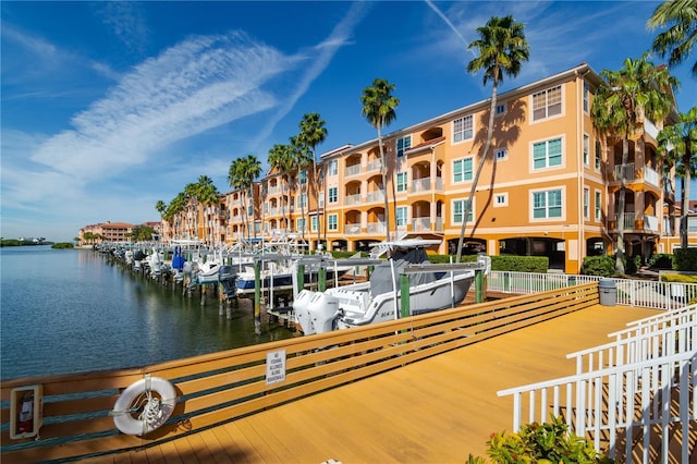 view of dock featuring a water view and fence