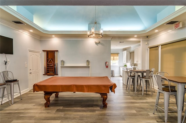 recreation room featuring light wood-style floors, ornamental molding, and recessed lighting