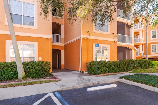 view of building exterior featuring uncovered parking