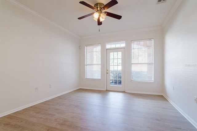 unfurnished room featuring ceiling fan, visible vents, baseboards, ornamental molding, and light wood finished floors