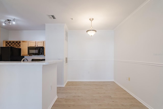 kitchen with light countertops, light wood-style flooring, light brown cabinets, black appliances, and baseboards