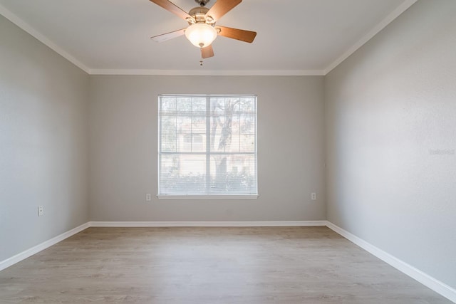 unfurnished room featuring light wood-type flooring, baseboards, a ceiling fan, and crown molding