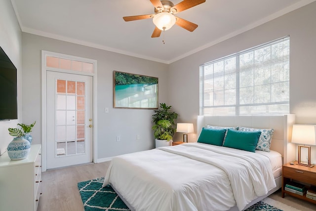 bedroom featuring ornamental molding, light wood-type flooring, baseboards, and a ceiling fan