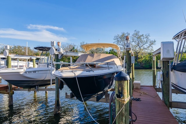 dock area with a water view and boat lift