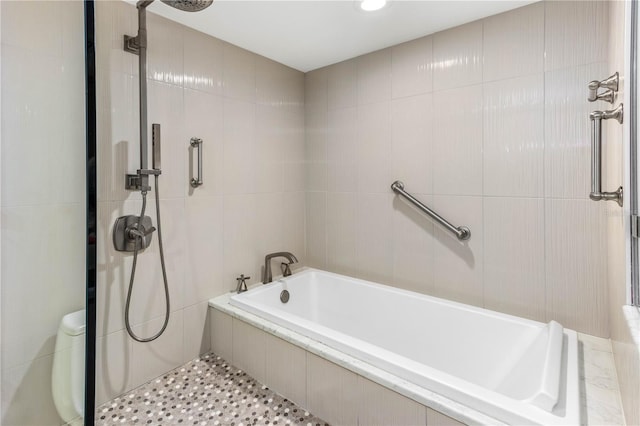 bathroom with plus walk in shower and tile walls