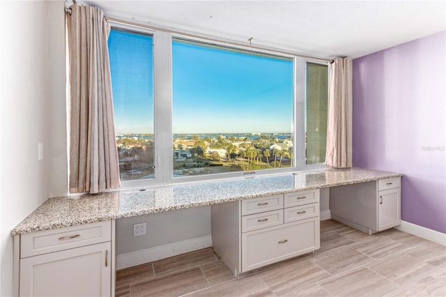 736 Island Way Unit 606, Clearwater Beach, FL 33767 - unfurnished office featuring built in desk, wood finish floors, plenty of natural light, and baseboards