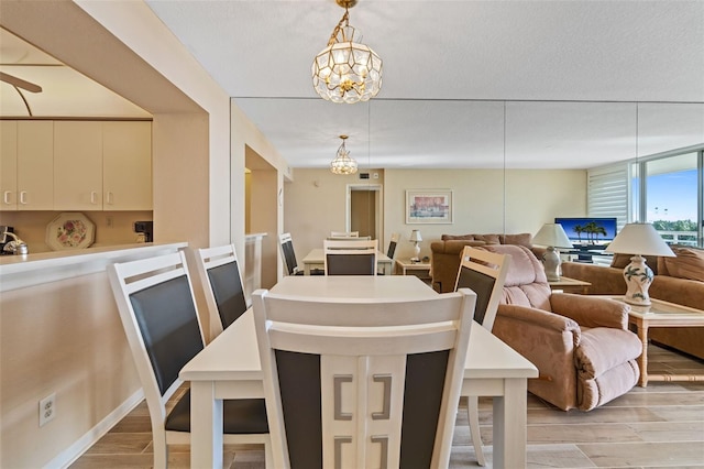 dining space with a notable chandelier and light wood-type flooring