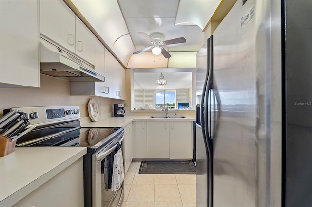 kitchen featuring sink, light tile patterned flooring, white cabinets, ceiling fan with notable chandelier, and appliances with stainless steel finishes