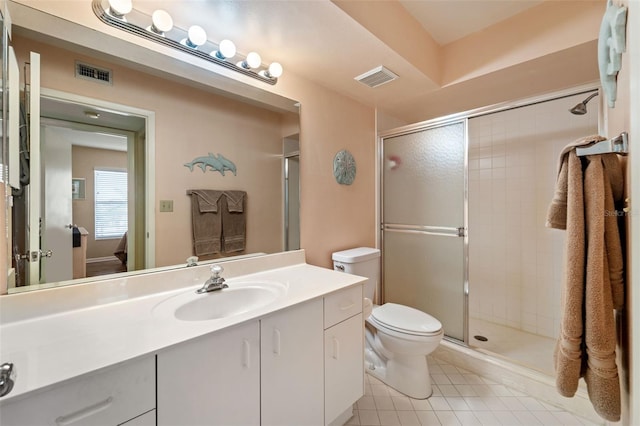 bathroom with tile patterned floors, vanity, toilet, and an enclosed shower