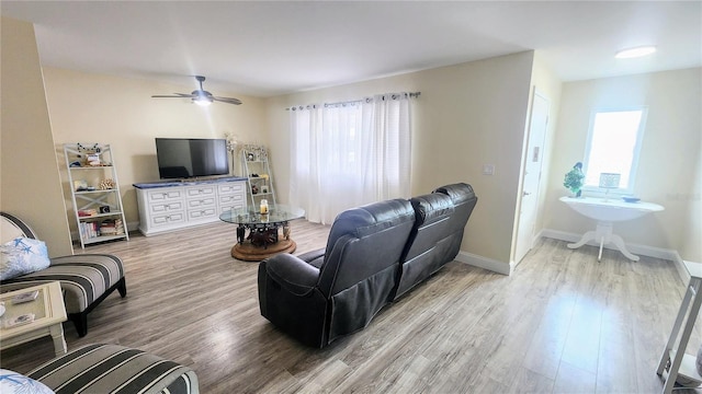 living room featuring hardwood / wood-style floors and ceiling fan