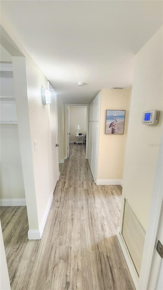 hall with light hardwood / wood-style floors