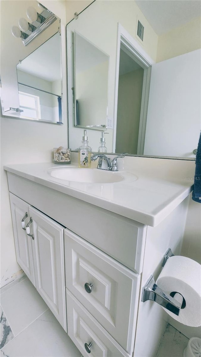 bathroom with tile patterned flooring and vanity