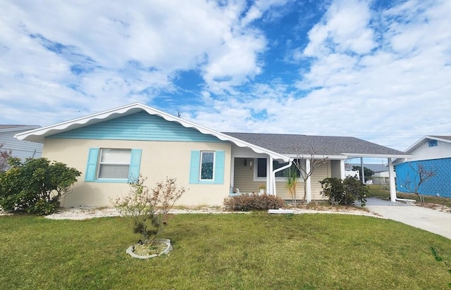 view of front of home with a front yard and a carport